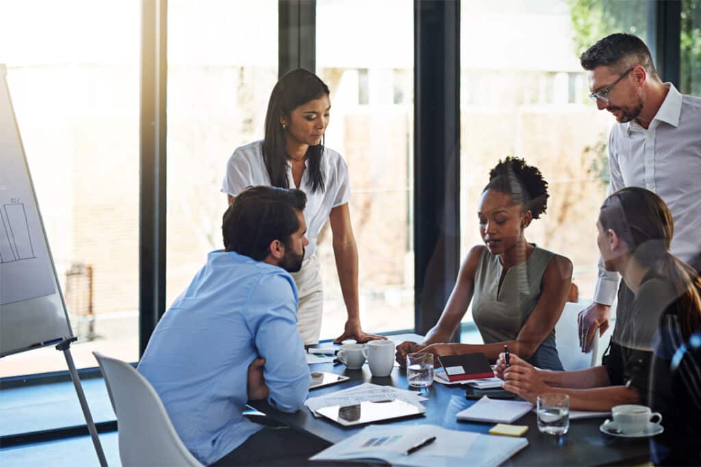 Employees and team leadership meet in a boardroom