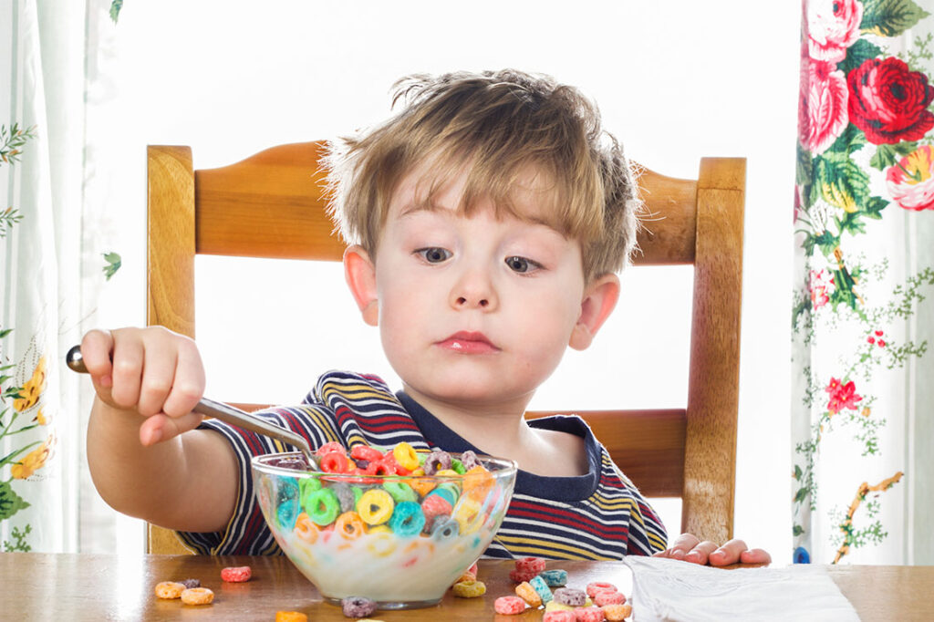 Young boy eating breakfast cereal