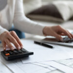 A woman calculates earnings from the best business to start with little money