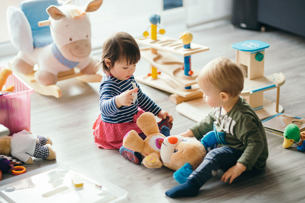 cute little girl and boy playing with toys