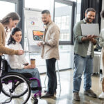 Diversity and inclusion in the workplace as a diverse group of coworkers work on a project together