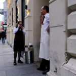 Hotel workers smoke cigarettes during their lunch break outside of a hotel in Vienna, Austria.
