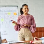Group of young business people having a meeting or presentation and seminar with whiteboard in the office