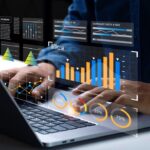 A man uses AI on his laptop to create and analyze data and graphs