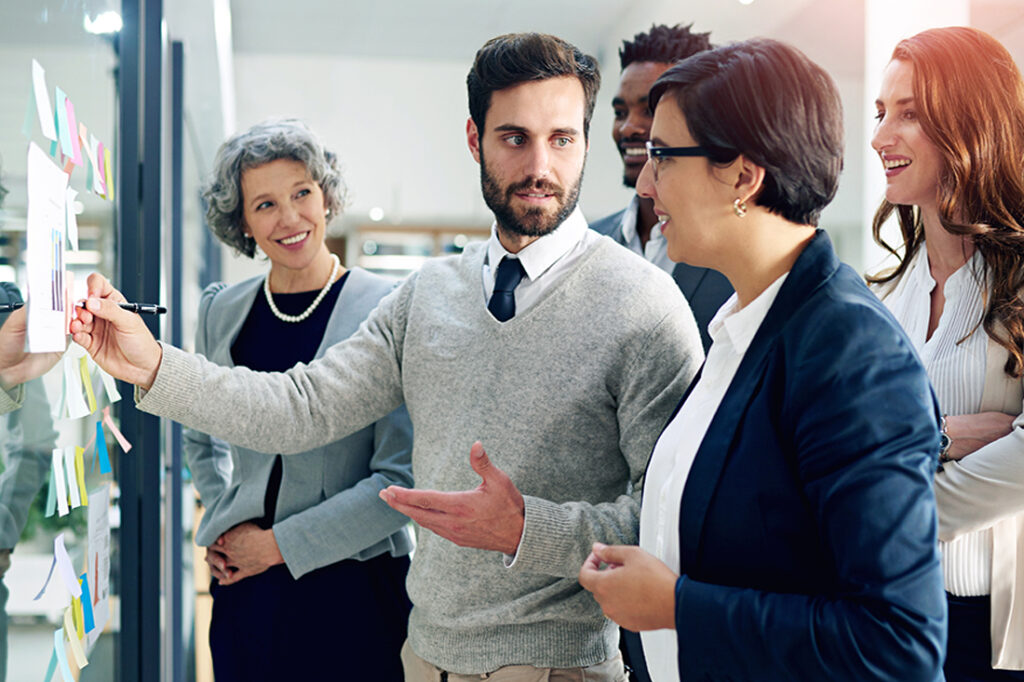 A team leader engages with a group of employees in a brainstorming session