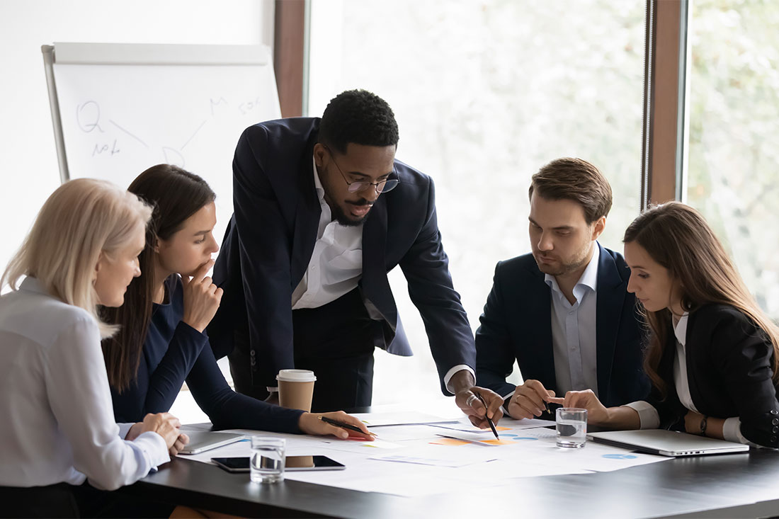 African American male boss work with diverse team at office meeting