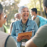 woman laughing planning with tablet for volunteer teamwork