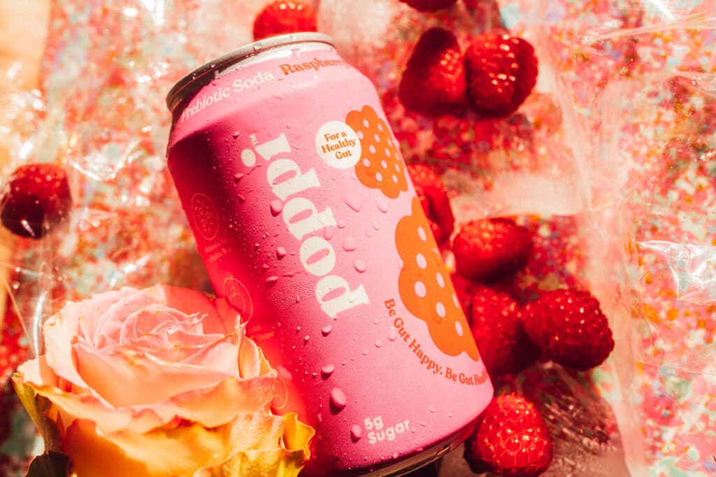 pink 12 oz can of Poppi Prebiotic Soda Raspberry Rose