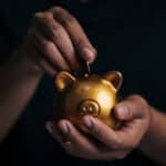 person putting money in a piggy bank, venture capital explanation