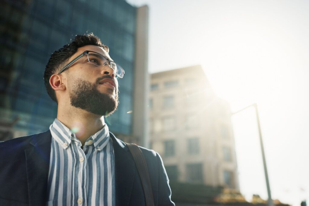 A professionally dressed man looking to the sun.