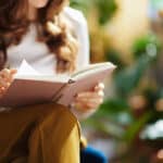 Woman reads book on sustainability
