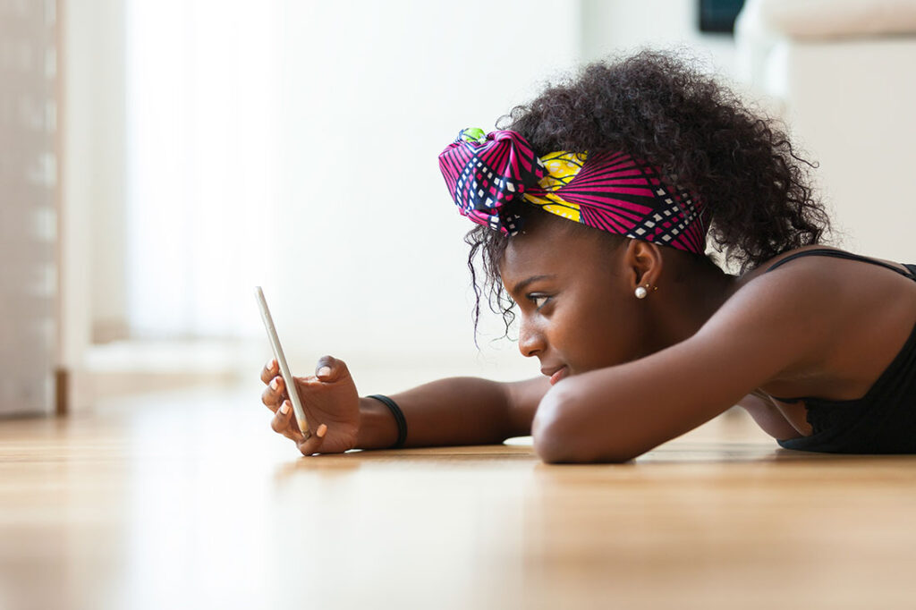 African American woman sending a text message on a mobile phone