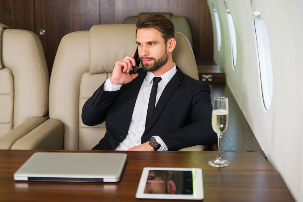 Businessman working while travelling on private jet