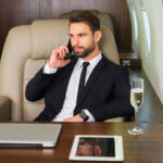 Businessman working while travelling on private jet