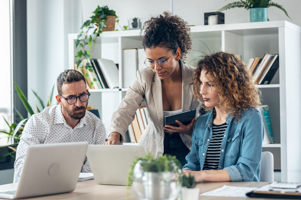 business team standing around computer for presentation of work in the office