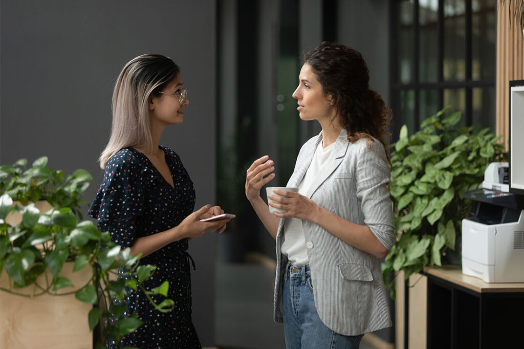two businesswoman discussing at workplace