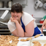 Entrepreneur Collette Divitto in a kitchen surrounded by cookies