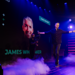 Speaker James Whittaker entering a stage.